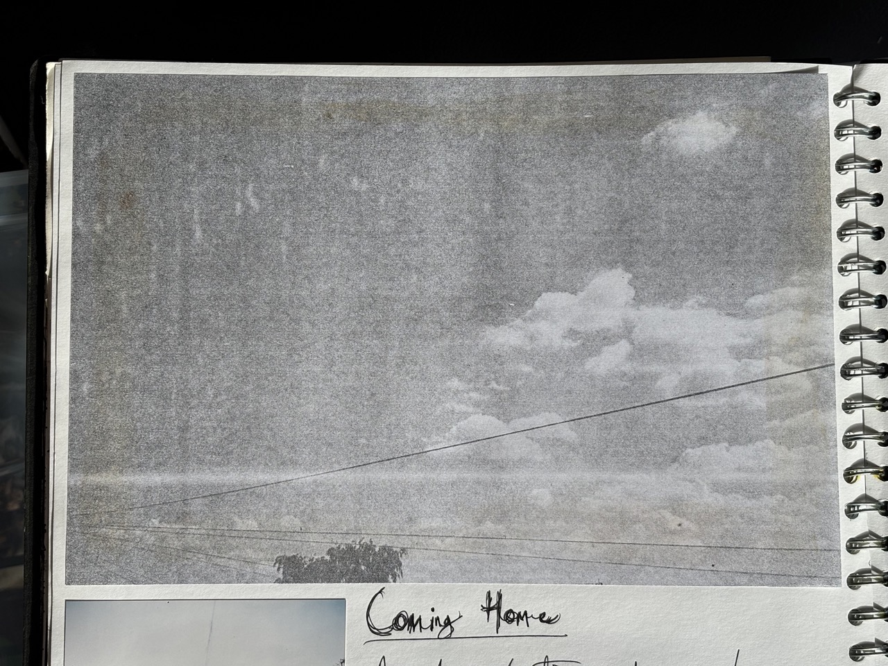 Photocopy of a photograph of a sky with telephone wires and clouds